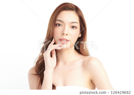 A beautiful young Asian woman with clean, fresh skin against a white background. Skincare, facial treatment, cosmetology, beauty, and spa. An elegant portrait of an Asian woman. 126429682