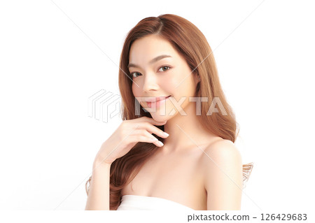 A beautiful young Asian woman with clean, fresh skin against a white background. Skincare, facial treatment, cosmetology, beauty, and spa. An elegant portrait of an Asian woman. 126429683