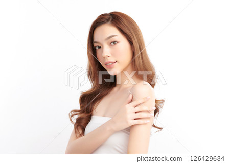 A beautiful young Asian woman with clean, fresh skin against a white background. Skincare, facial treatment, cosmetology, beauty, and spa. An elegant portrait of an Asian woman. 126429684