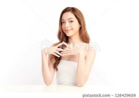 A beautiful young Asian woman with clean, fresh skin against a white background. Skincare, facial treatment, cosmetology, beauty, and spa. An elegant portrait of an Asian woman. A beautiful young Asian woman with clean, fresh skin against a white background. Skincare, facial treatment, cosmetology, beauty, and spa. An elegant portrait of an Asian woman. 126429689