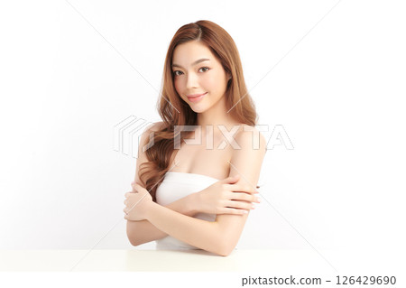 A beautiful young Asian woman with clean, fresh skin against a white background. Skincare, facial treatment, cosmetology, beauty, and spa. An elegant portrait of an Asian woman. A beautiful young Asian woman with clean, fresh skin against a white background. Skincare, facial treatment, cosmetology, beauty, and spa. An elegant portrait of an Asian woman. 126429690