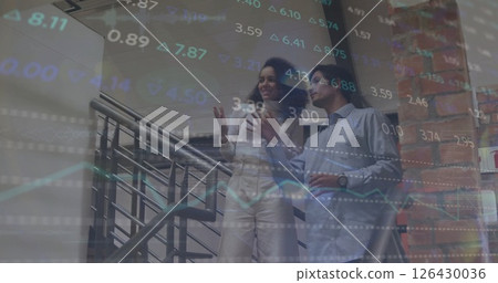 Image of diagrams and stock market over diverse colleagues talking in office 126430036