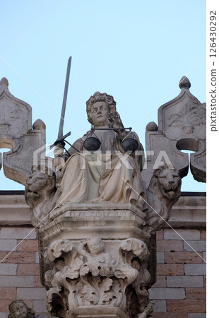 Goddess of Justice, statue at the top of Doge Palace in Venice, holding balance scales and sword, erected in 1579, Venice, Italy Goddess of Justice, statue at the top of Doge Palace in Venice, holding balance scales and sword, erected in 1579, Venice, Italy 126430292