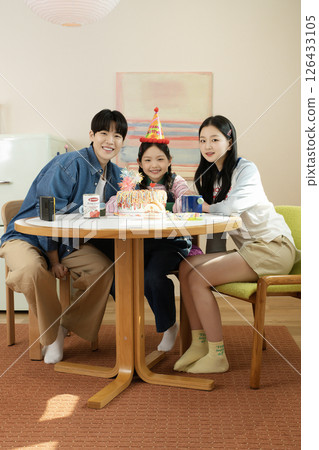 A family enjoying their daughter's birthday party at home 126433105