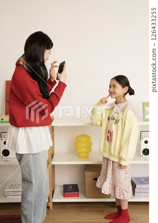 Mother filming her daughter's challenge Mother filming her daughter's challenge 126433255