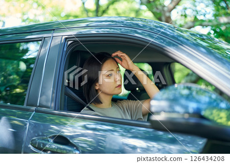 A woman driving a car A woman driving a car 126434208