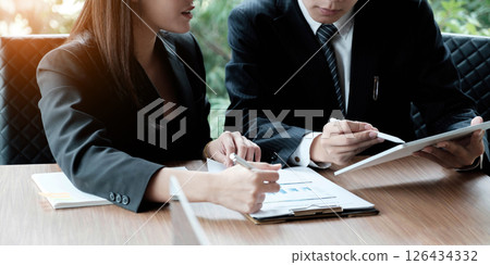 Fund managers team consultation and discuss about analysis Investment stock market by digital tablet. 126434332