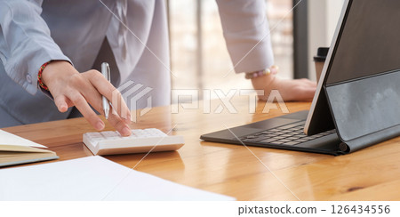 Close up of businesswoman accountant or banker making calculations.Business Financing Accounting Banking Concept. Close up of businesswoman accountant or banker making calculations.Business Financing Accounting Banking Concept. 126434556