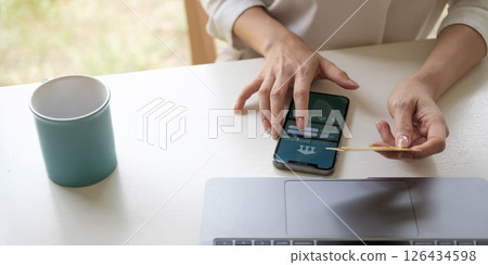 businesswoman hand using smart phone, tablet payments and holding credit card online shopping, omni channel, digital tablet docking keyboard computer at office in sun light businesswoman hand using smart phone, tablet payments and holding credit card online shopping, omni channel, digital tablet docking keyboard computer at office in sun light 126434598