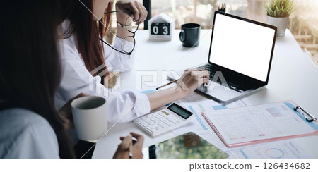 Businessman working on analysis charts and graphs showing results.Her hand holds the pen and points to the graph.Business analysis and strategy. Businessman working on analysis charts and graphs showing results.Her hand holds the pen and points to the graph.Business analysis and strategy. 126434682