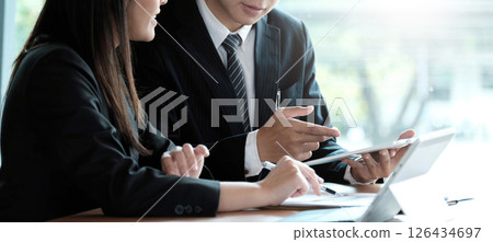 Fund managers team consultation and discuss about analysis Investment stock market by digital tablet. 126434697