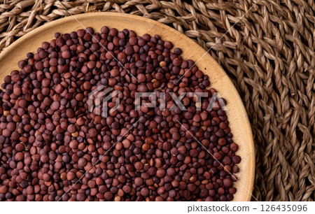 Organic uncooked seeds dark red brown lentils. Organic uncooked seeds dark red brown lentils. 126435096