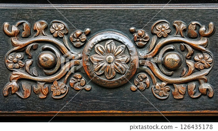 Close-up of a vintage door handle with intricate designs.. 126435178