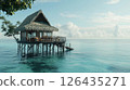 Cozy cafe perched on stilts over the water, with clear views of the ocean.. 126435271