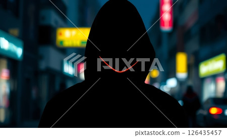 hooded figure in city street at night with glowing signs and streetlights for use in urban lifestyle, night photography, or atmospheric scenes hooded figure in city street at night with glowing signs and streetlights for use in urban lifestyle, night photography, or atmospheric scenes 126435457
