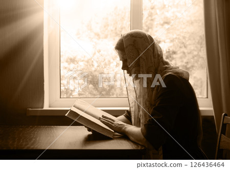 Young woman reading the old book 126436464