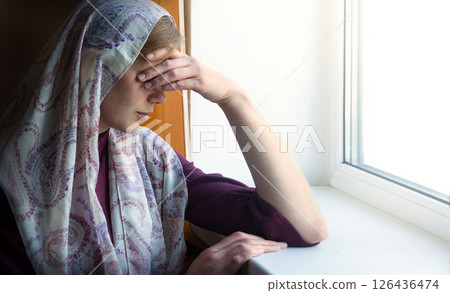 Woman thinking at the window 126436474