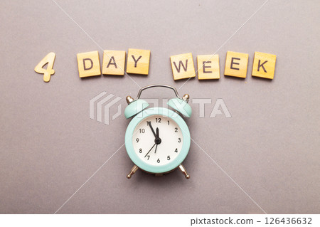 inscription four day week making by wooden cubes on grey background 126436632