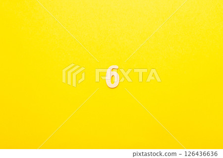 Top view of wooden number 6 six on yellow bright background. Top view of wooden number 6 six on yellow bright background. 126436636