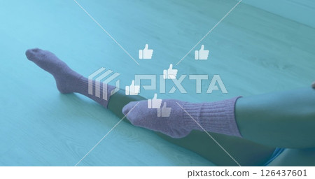 Thumbs up icons image over person wearing purple socks on wooden floor Thumbs up icons image over person wearing purple socks on wooden floor 126437601