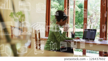 Working on laptop, woman surrounded by business analytics and data icons image 126437602