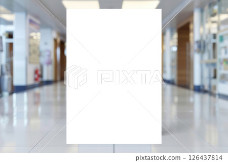 Mock-Up promotion poster displayed on the front of bright blur medical clinic, hospital interior background with defocused effect. Blank A4 white paper on abstract defocused luxury office corridor. Ad 126437814