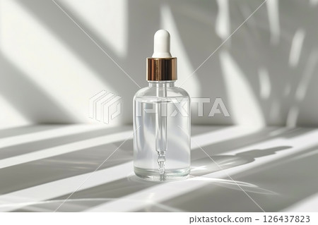 Natural oil cosmetics. Dropper glass Bottle Mock-Up. Oily cosmetic pipette. Face and body treatment. Spa concept. Mineral organic liquid. Front view. Beauty products. Blank packaging gel, white table 126437823