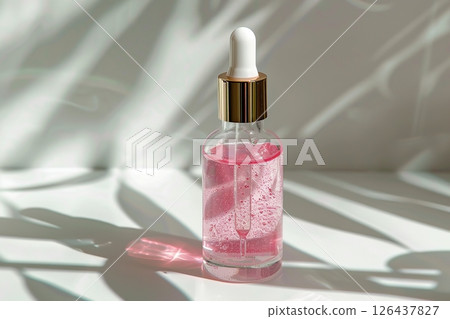 Natural oil cosmetics. Dropper glass Bottle Mock-Up. Oily cosmetic pipette. Face, body treatment. Spa concept. Mineral organic pink liquid. Front view. Beauty product. Blank packaging gel, white table 126437827