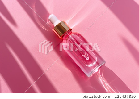 Natural oil cosmetics. Dropper glass Bottle Mock-Up. Oily cosmetic pipette. Face, body treatment. Spa concept. Mineral organic pink liquid. Top view. Beauty product. Blank packaging gel, white table 126437830