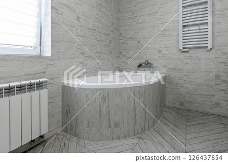 Corner Bathtub in Bright Modern Bathroom 126437854