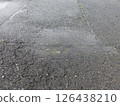 Puddles in depressions on asphalt roads 126438210
