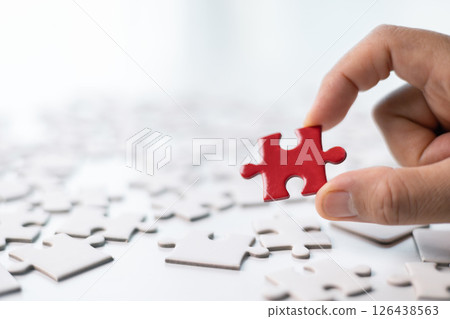 Team with piece of jigsaw puzzle as critical component of business strategy, understanding teamwork and collaboration were essential for achieving success and realizing concept of well-executed plan. 126438563