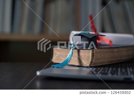 Background of graduation ceremony, people celebrated success of students receiving their higher education certificates, adorned with ribbon, against backdrop of black caps. education, higher. 126438802
