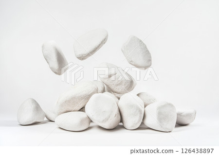 A collection of white angular stones is stacked in a modern arrangement, showcasing simplicity and elegance against a light backdrop 126438897