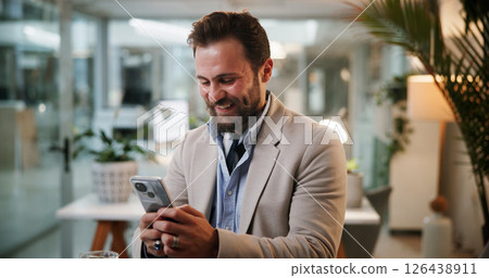 Business man, cellphone and night in office for communication, contact or funny email. Male employee, overtime and scroll technology for corporate feedback, social media and meme on internet 126438911