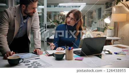 Business people, notebook and tablet in office for discussion, project feedback and advice at night. Journalist team, planning and tech in agency for article notes, collaboration and late information Business people, notebook and tablet in office for discussion, project feedback and advice at night. Journalist team, planning and tech in agency for article notes, collaboration and late information 126438955