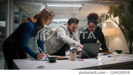 Leader, project and business people on laptop for planning, collaboration and investment news. Manager, night and financial advisor pointing in meeting for teamwork, accounting or risk management 126438956