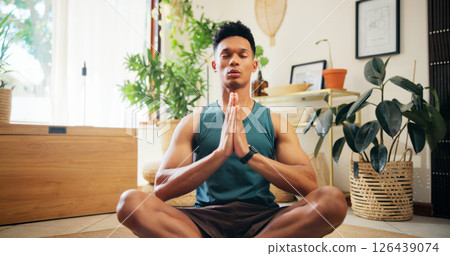 Man, namaste and meditation for yoga at house for fitness, zen balance and mindfulness in lounge. Male person, eyes closed and chakra routine of morning peace, spiritual healing and holistic wellness 126439074