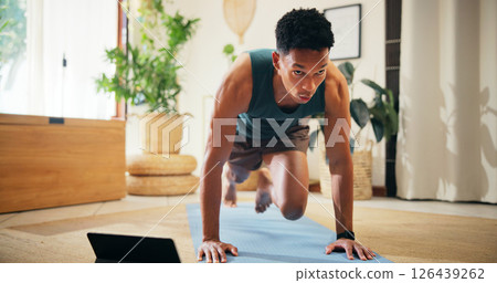 Man, tablet or gym tutorial for plank exercise, online course or balance for strong core muscle. Streaming, routine or mountain climbers in virtual class for fitness, abs workout or training in home Man, tablet or gym tutorial for plank exercise, online course or balance for strong core muscle. Streaming, routine or mountain climbers in virtual class for fitness, abs workout or training in home 126439262