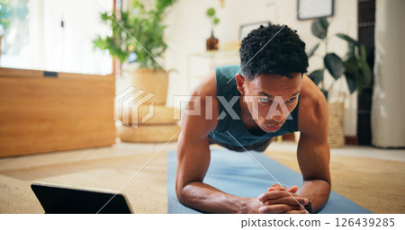 Man, tablet and tutorial for plank exercise, online course or balance with strong core muscle. Streaming, lounge and person in virtual class for fitness, workout program or training for abs in home 126439285
