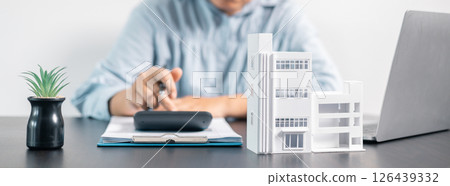 Real estate agent helped the client secure a mortgage loan for their property investment, ensuring the contract was properly handled by the broker. investment, property, estate, loan, real, mortgage. 126439332