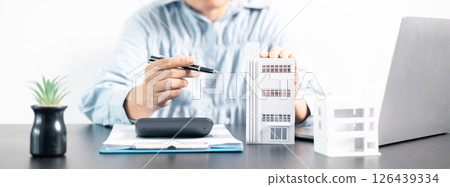 Real estate agent helped the client secure a mortgage loan for their property investment, ensuring the contract was properly handled by the broker. investment, property, estate, loan, real, mortgage. 126439334
