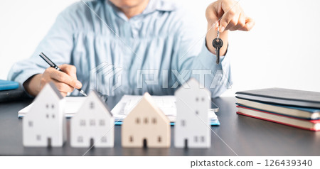 Real estate agent helped the client secure a mortgage loan for their property investment, ensuring the contract was properly handled by the broker. investment, property, estate, loan, real, mortgage. 126439340