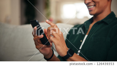 Relax, hands and phone with man on sofa for social media, movie platform and streaming service. Happiness, entertainment app and subscription with person in living room at home for multimedia search Relax, hands and phone with man on sofa for social media, movie platform and streaming service. Happiness, entertainment app and subscription with person in living room at home for multimedia search 126439353
