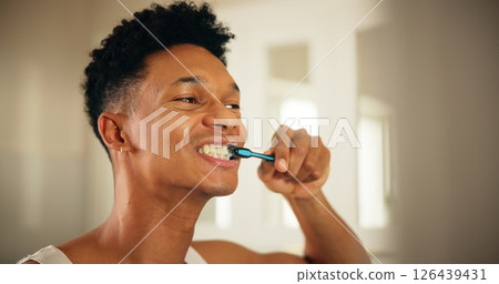 Home, man and dental with toothbrush for wellness, oral care and mouth treatment in morning routine. Bathroom, male person and health with teeth whitening for gum, hygiene and grooming in apartment 126439431