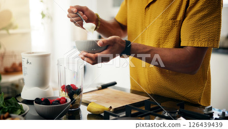 Berries, blender and hands with man in kitchen of home for hobby, meal prep or nutrition. Ingredients, recipe or smoothie and person with bowl in apartment for breakfast, diet or health as chef 126439439