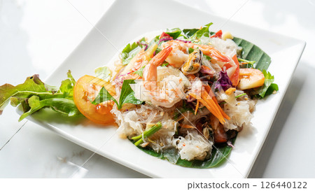 Glass noodle spicy salad on a wooden table. 126440122