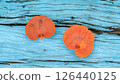 Fan-shaped jelly fungus growing on a blue wooden. 126440125