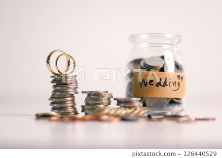 Save money for a wedding, wise to manage your finance by investing in gold, utilizing banking services, and understanding the broader economy and currency business, even down to every last coin. 126440529