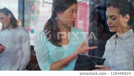 Image of caucasian business people discussing work in office over colleagues Image of caucasian business people discussing work in office over colleagues 126440924